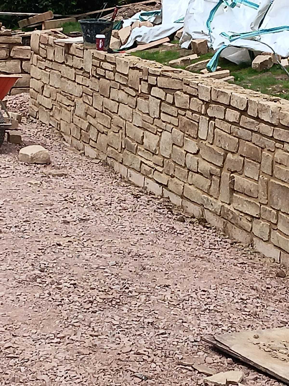 Coursed natural stone boundary wall